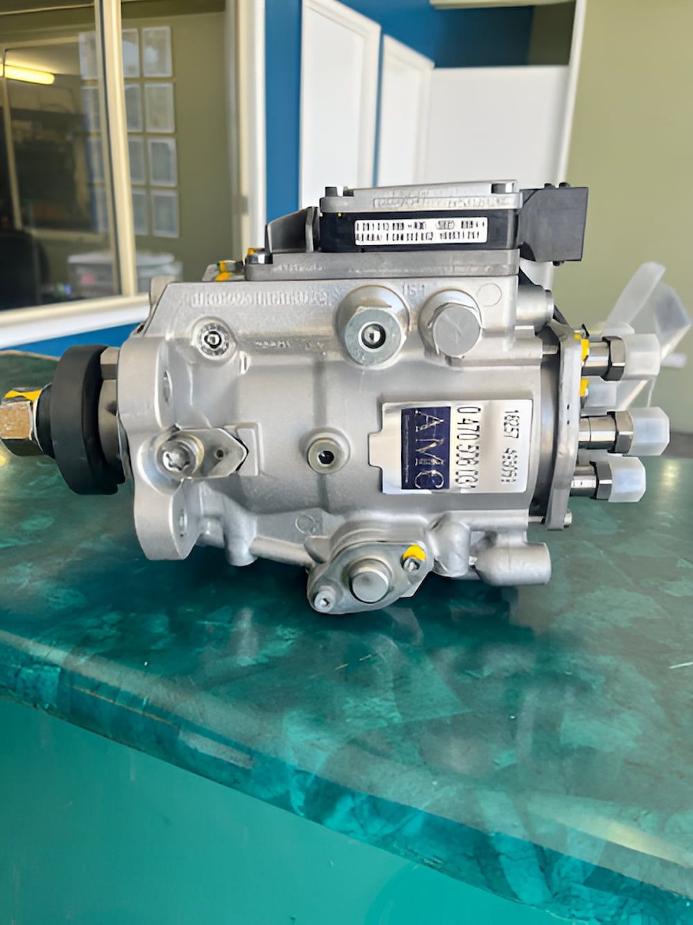 A Fuel Pump Is Sitting On Top Of A Glass Table — AMC Diesel Fuel Injection Services In Paget, QLD