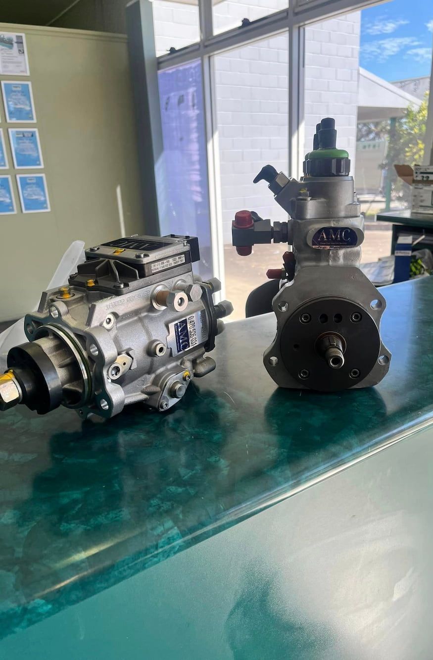 Two Fuel Pumps Are Sitting On A Counter In A Room — AMC Diesel Fuel Injection Services In Paget, QLD
