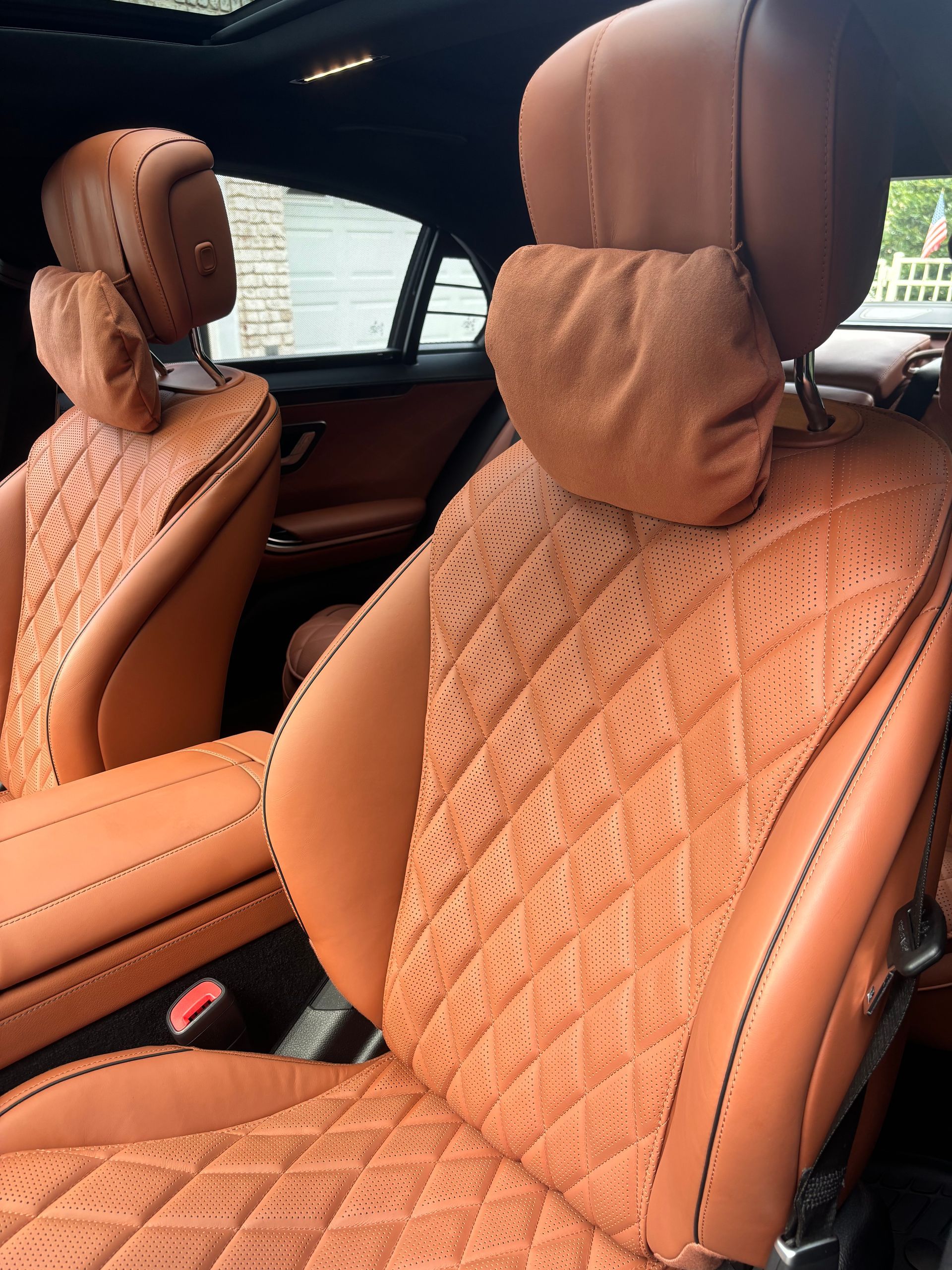 Tan leather interior after deep conditioning and detailing on luxury vehicle.