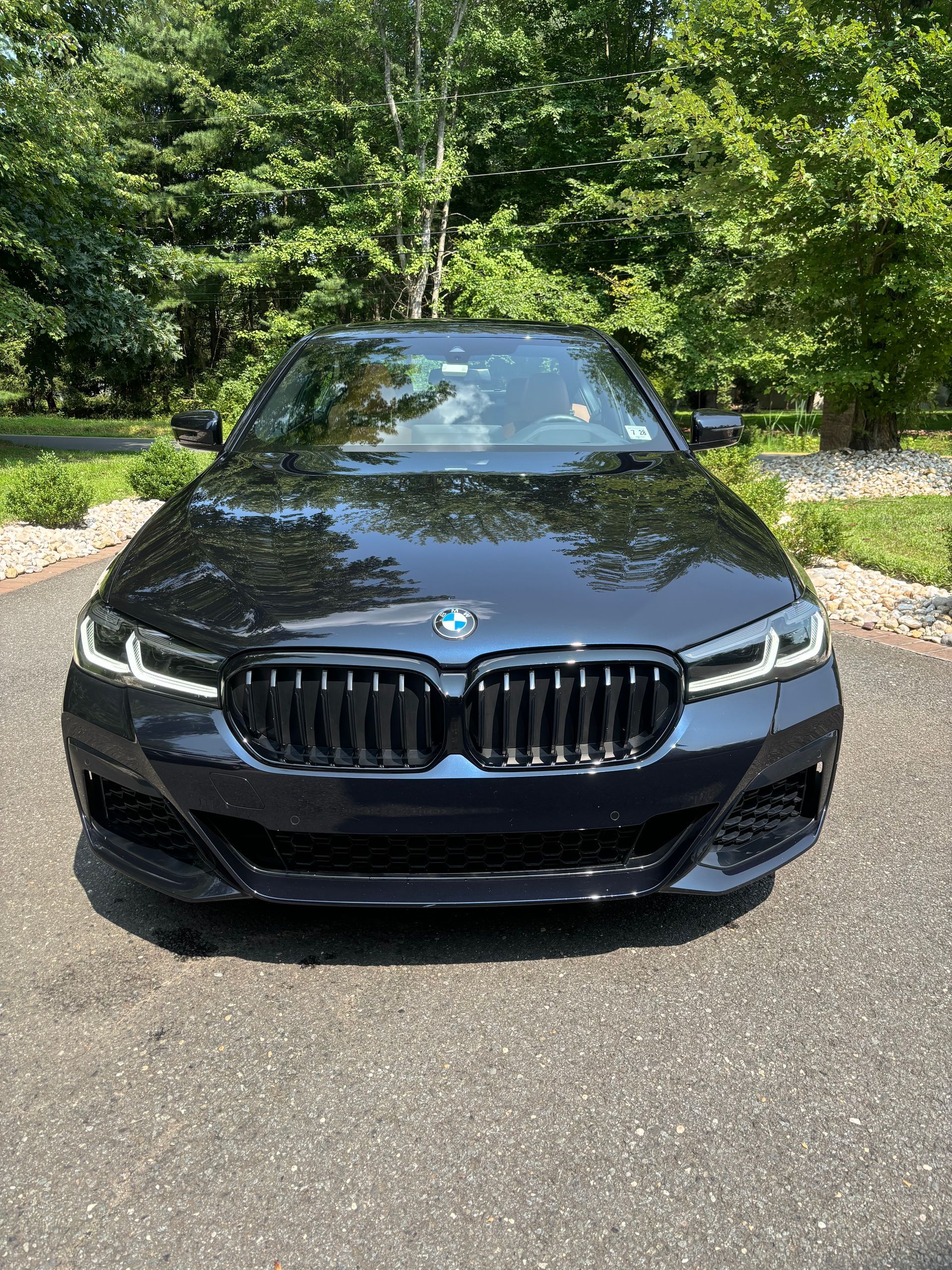 Luxury sedan exterior showing mirror-like shine after complete detailing and polish.
