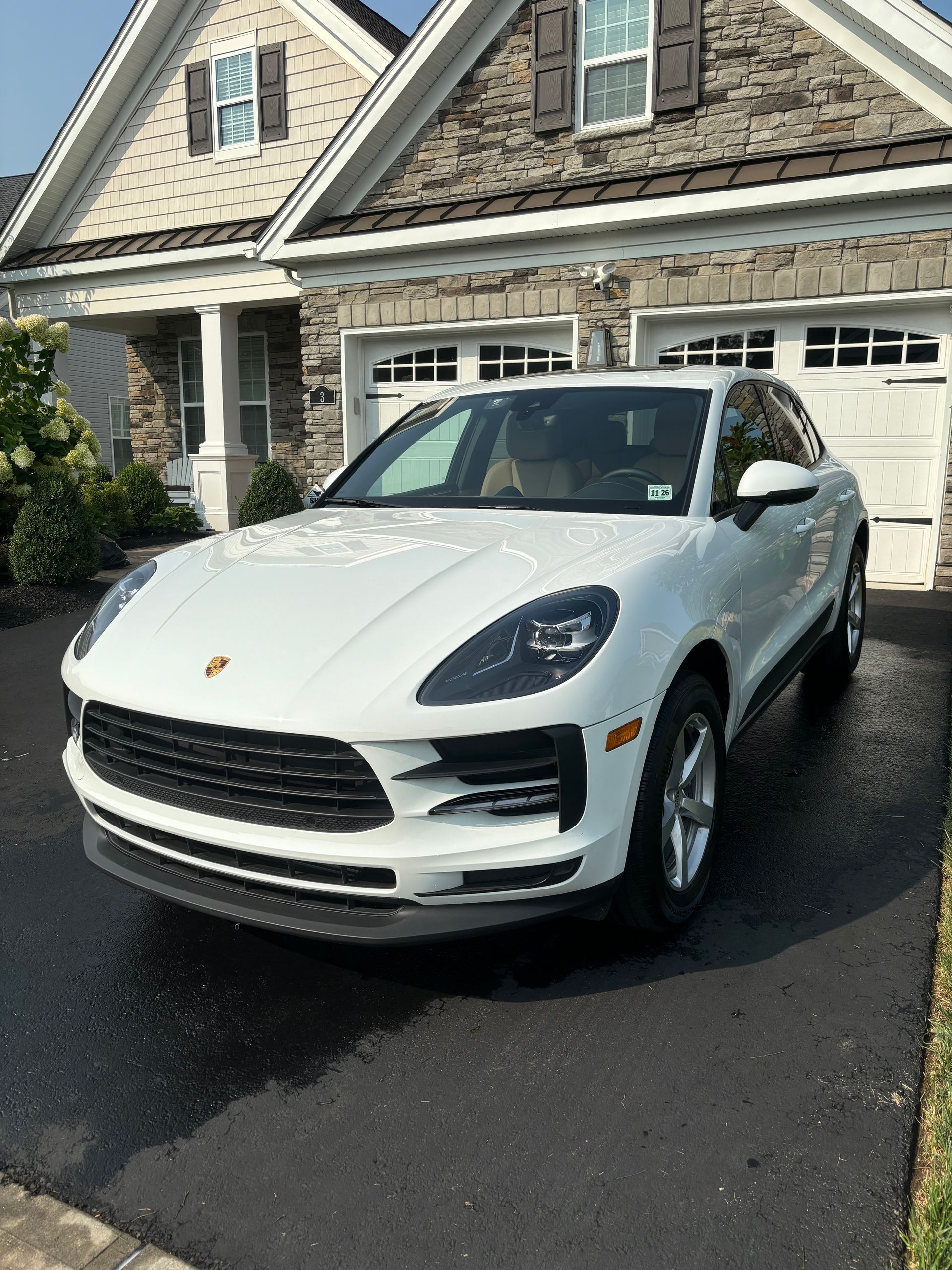 Luxury sedan after full hand wash and ceramic coating at residential detailing service.