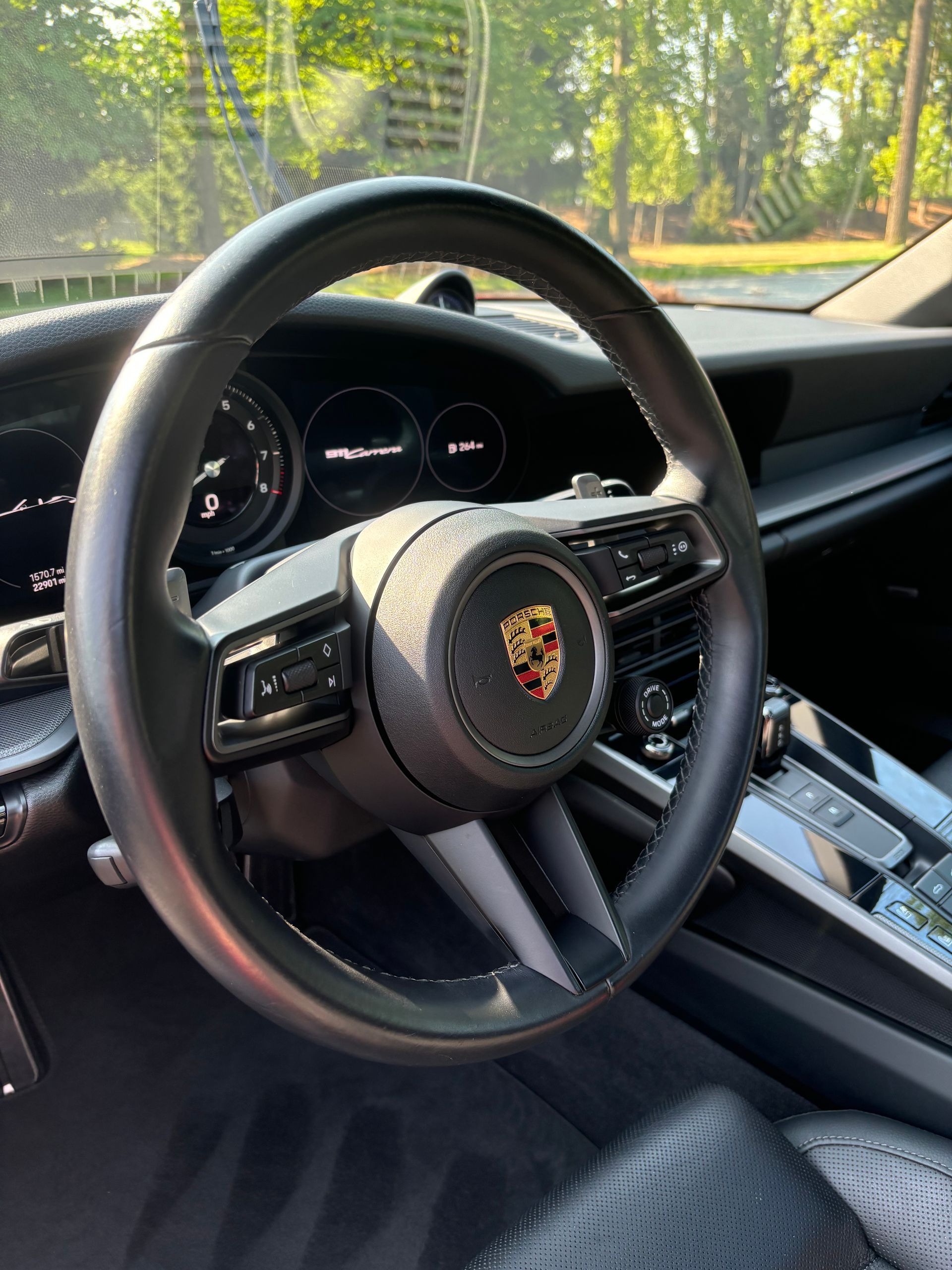 Steering wheel and dashboard view after interior cleaning and conditioning service.