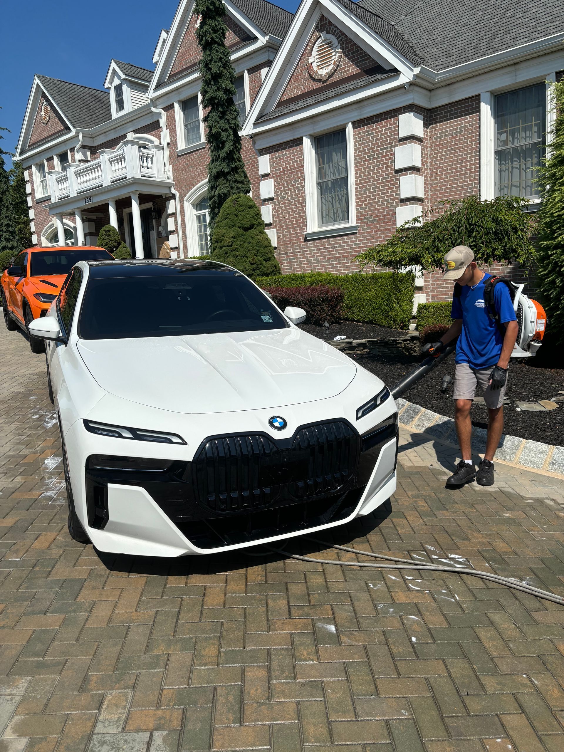 Luxury vehicles lined up for mobile detailing service at residential home in New Jersey.