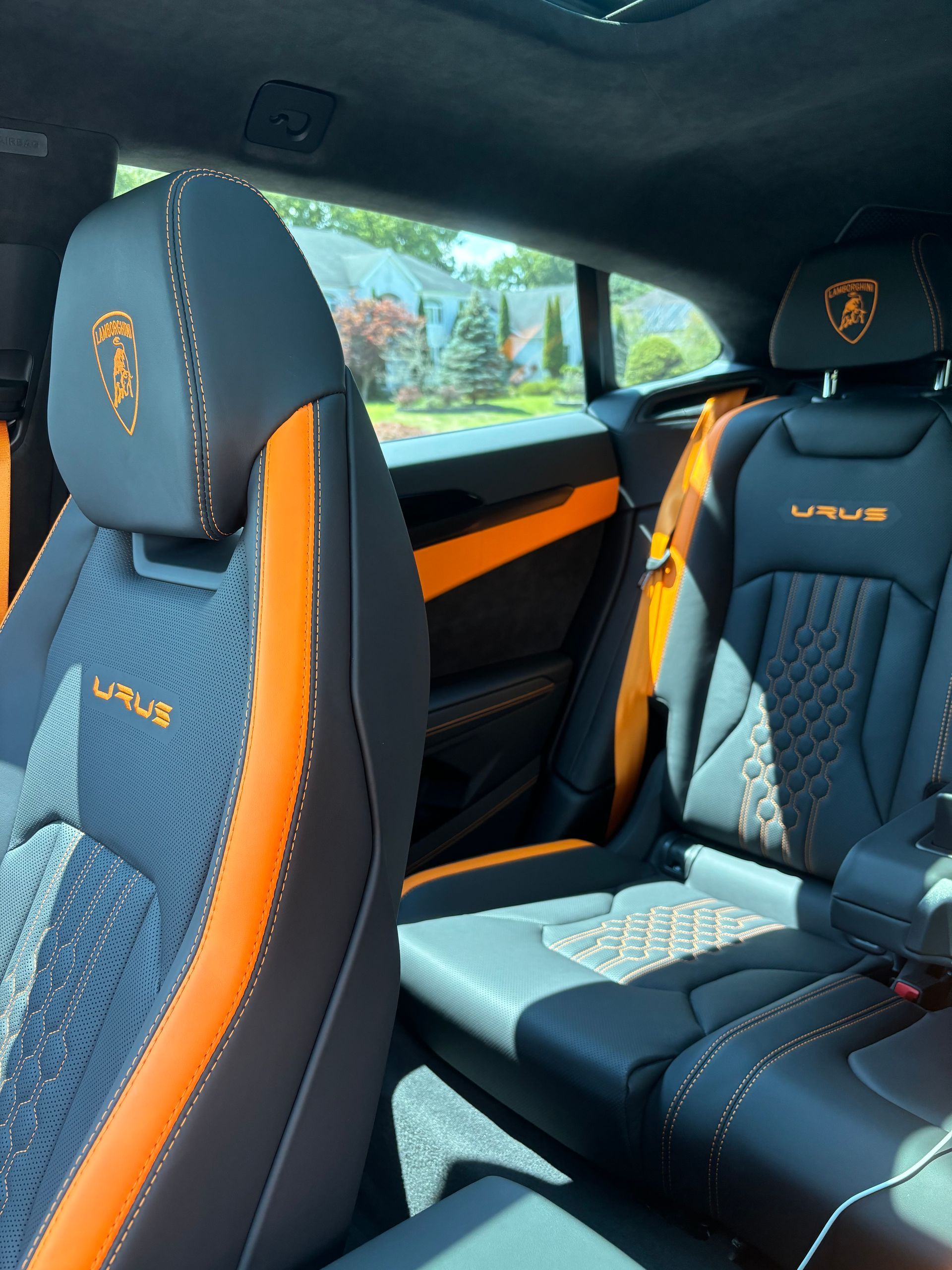 Lamborghini Urus seats with orange accents after interior detailing and conditioning.