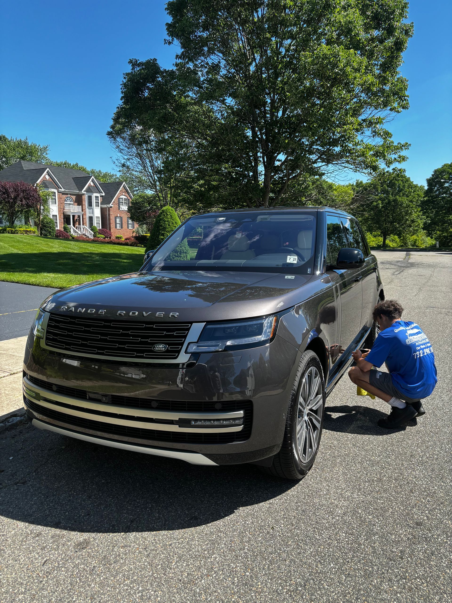 Luxury sedan exterior gleaming in sunlight after ceramic coating application.