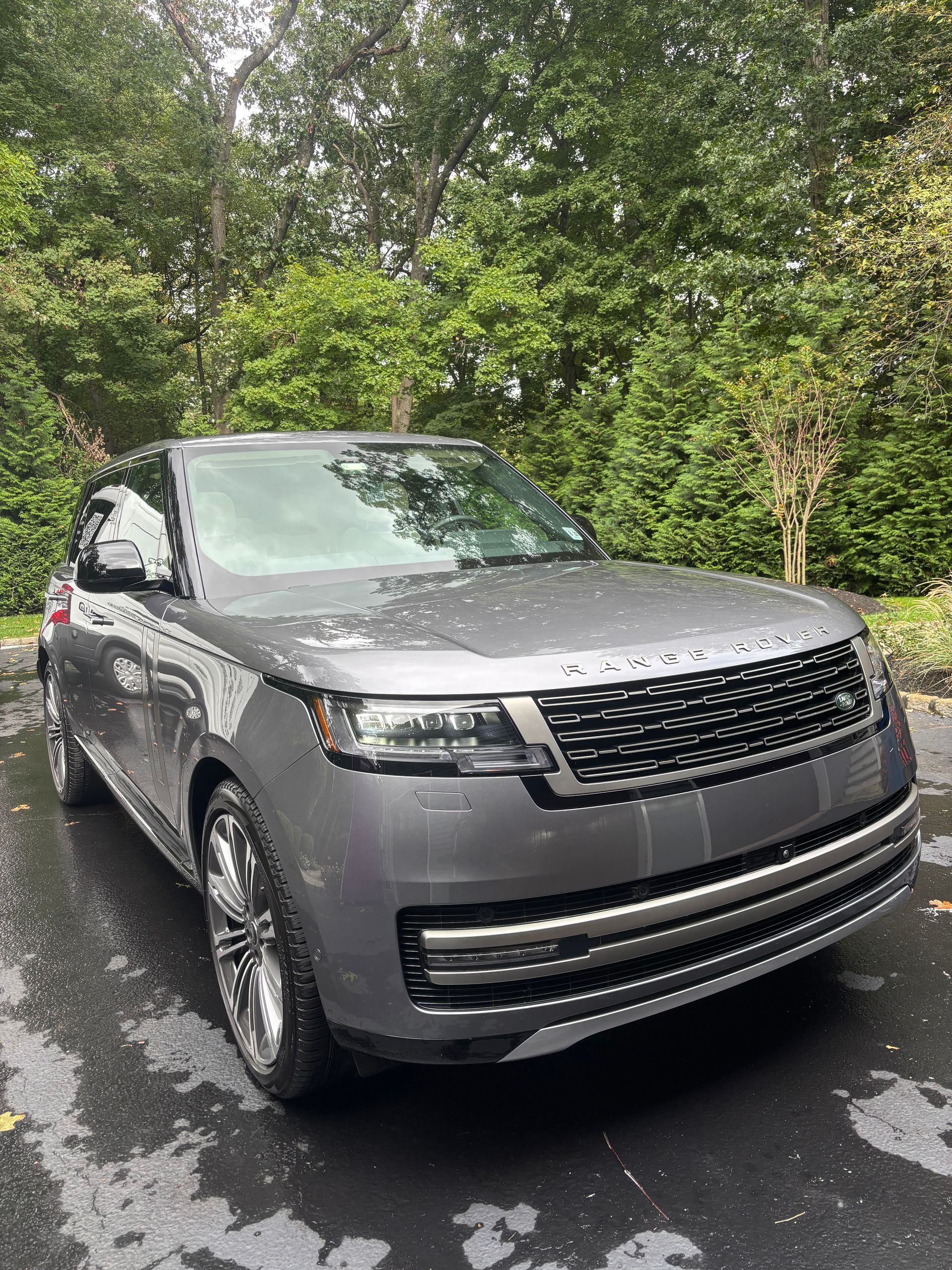 Silver car reflecting sunlight after professional detailing and ceramic coating service.