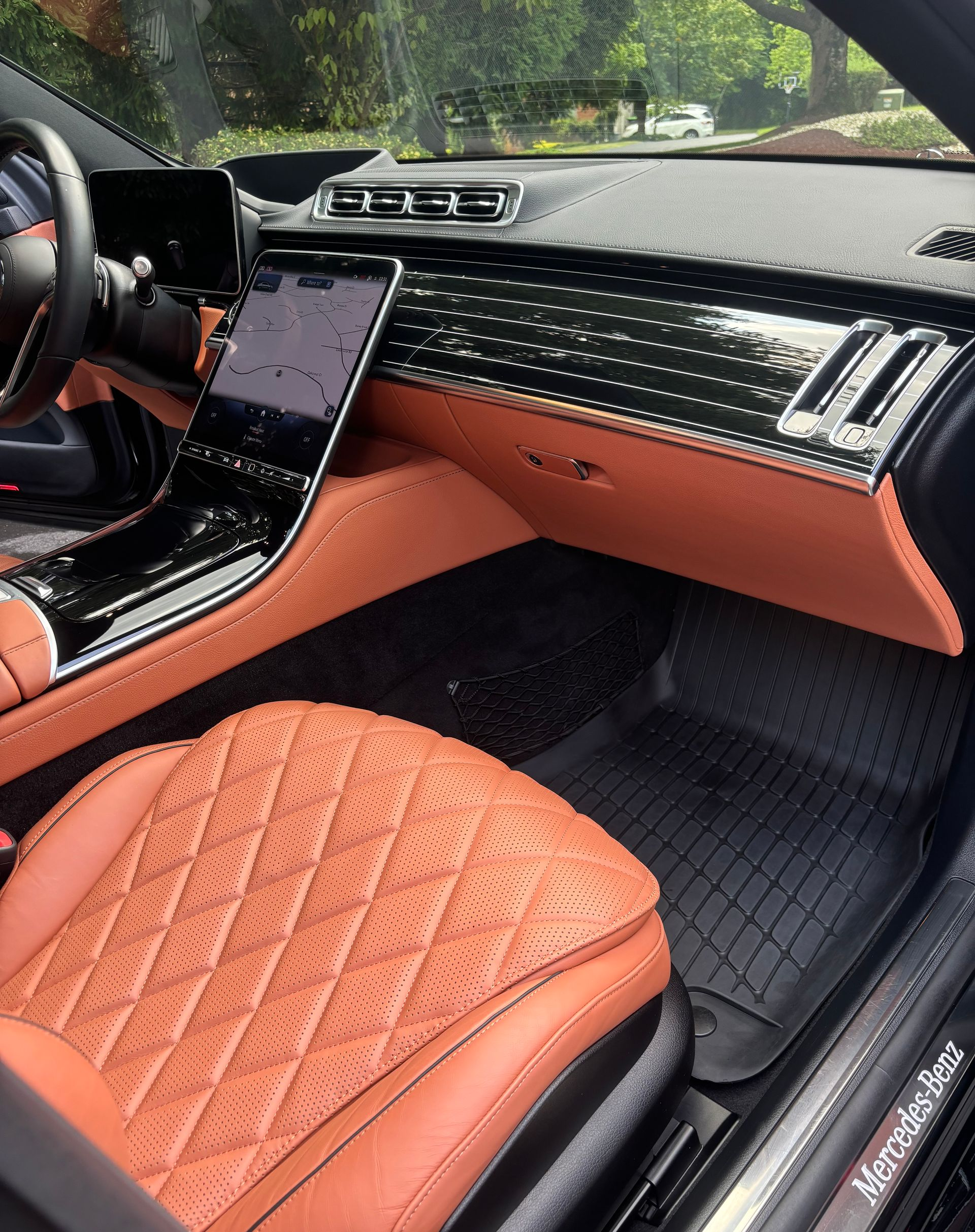 Luxury car interior with polished black trim and conditioned leather detailing.