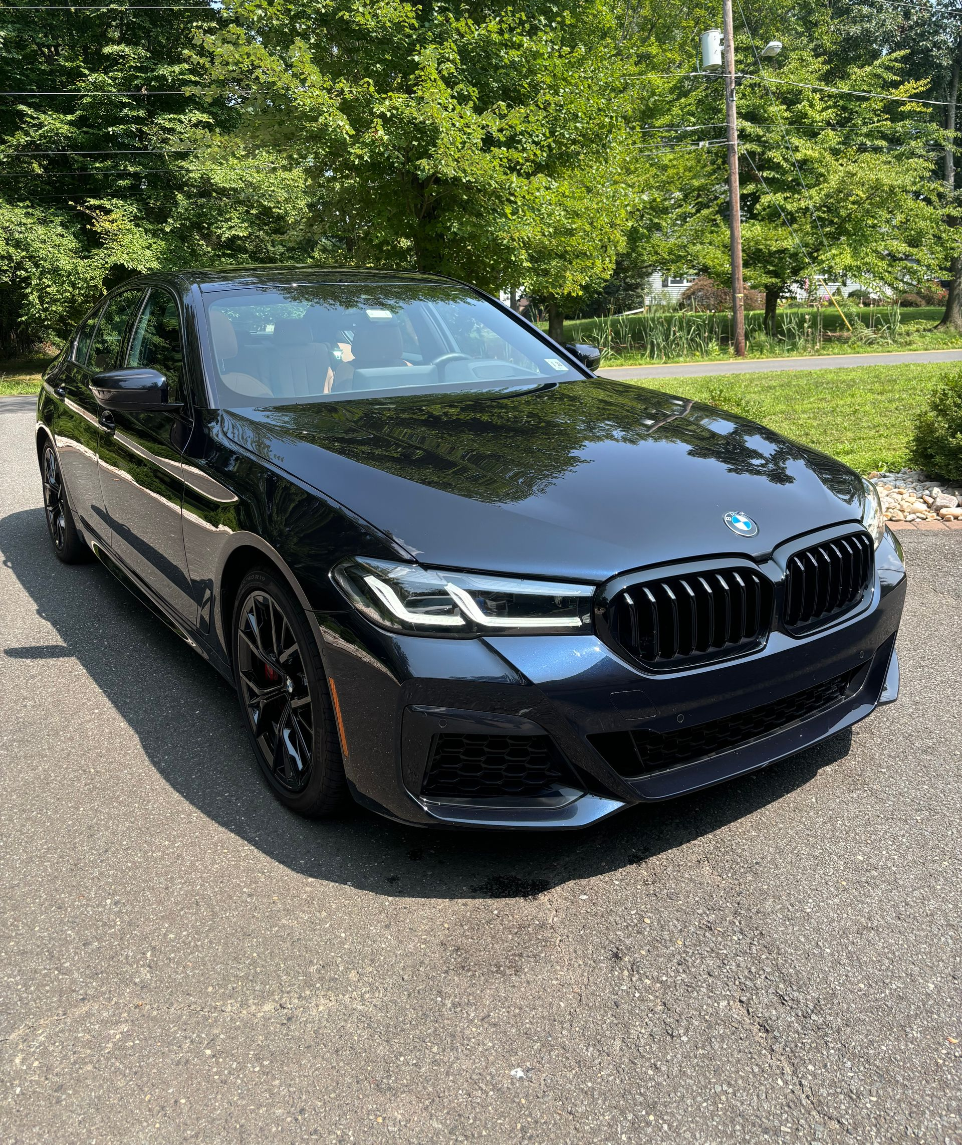 Black BMW exterior after professional paint correction and gloss enhancement service.