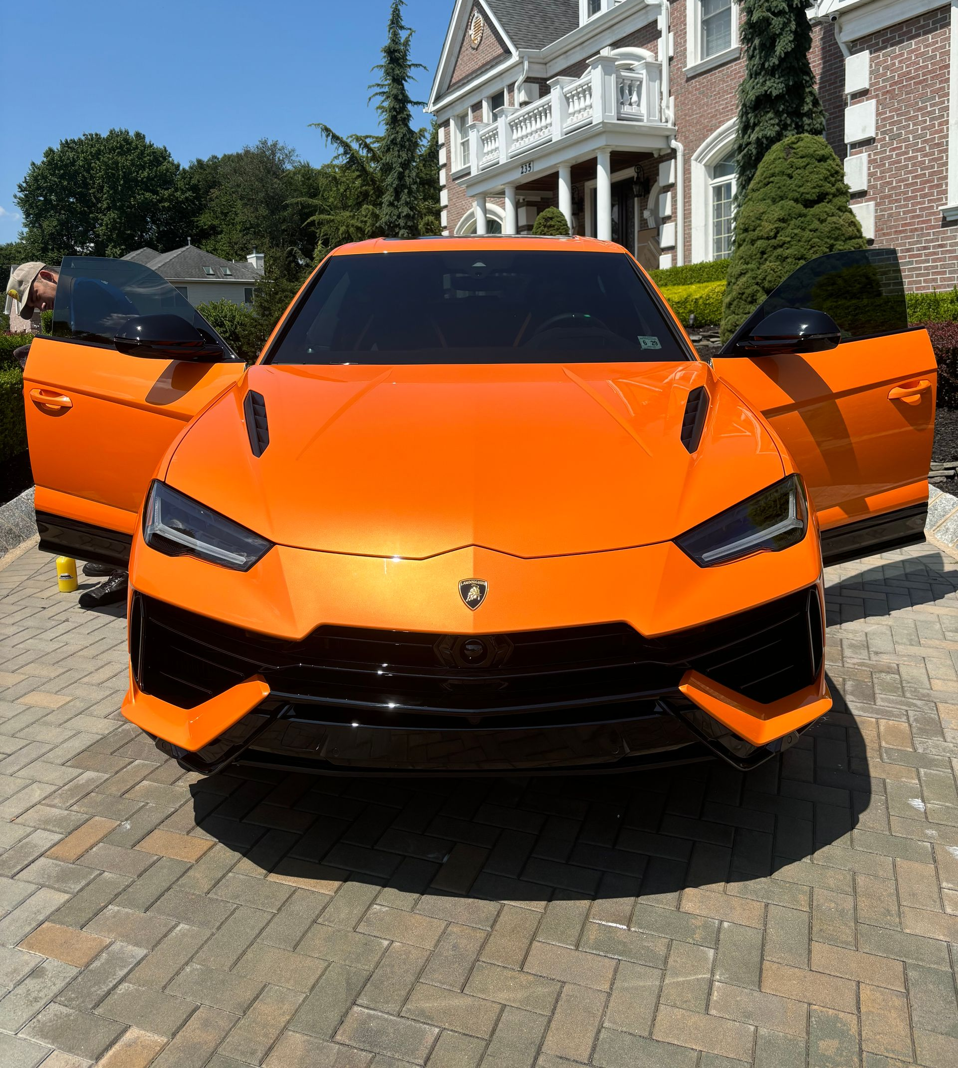 Bright orange Lamborghini Urus after exterior detailing and ceramic coating for a flawless high-gloss finish.