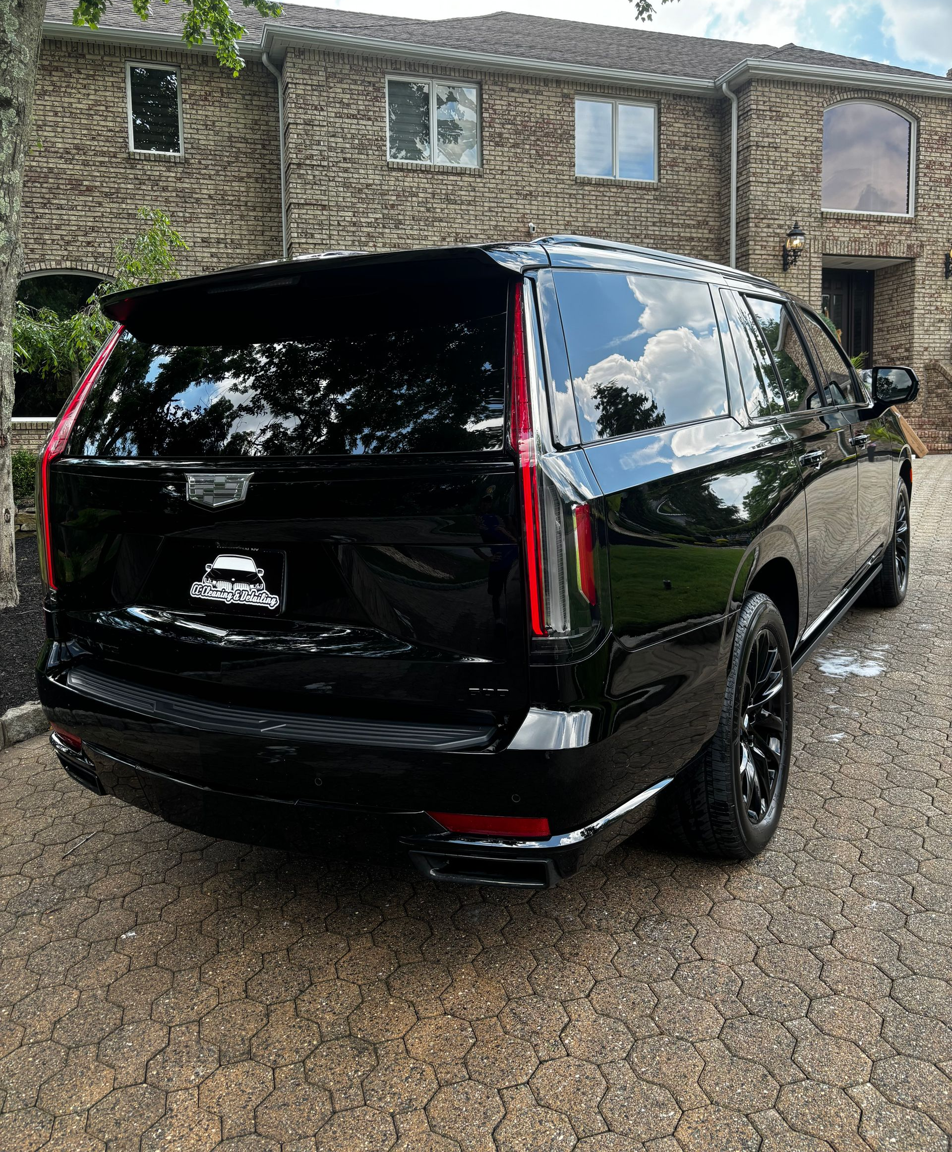 Black Cadillac SUV with mirror-like finish after full detail by CC Cleaning & Detailing NJ.