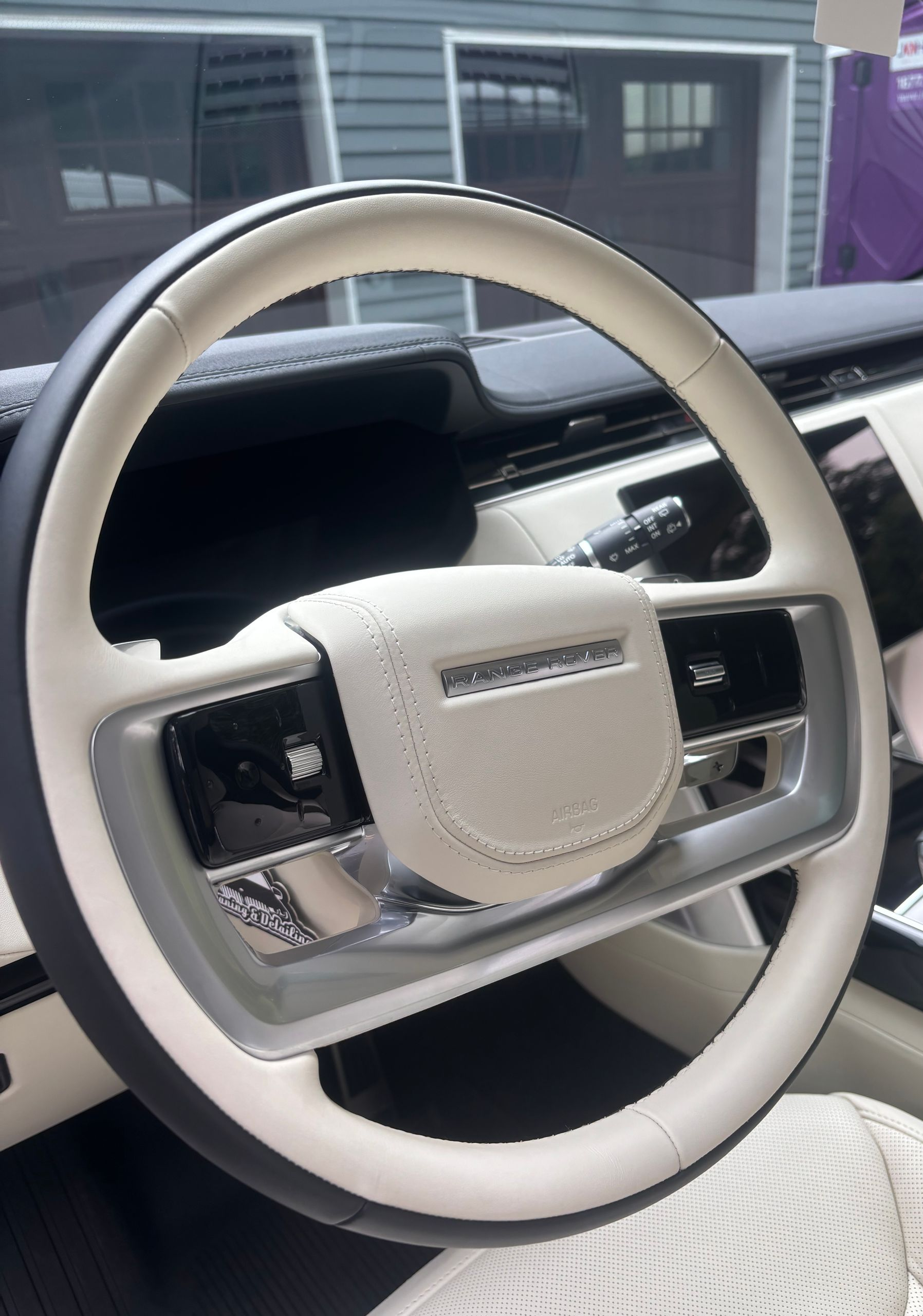 White leather steering wheel and dashboard after luxury interior detailing treatment.