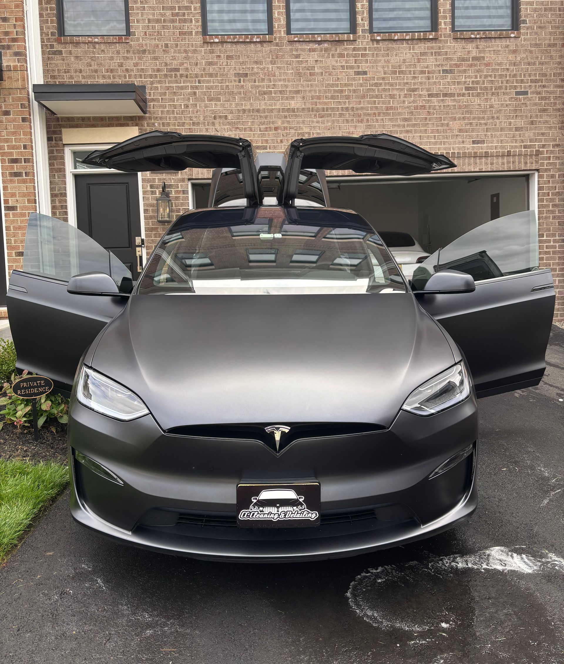 Tesla Model X with open doors after luxury detailing and interior restoration service.