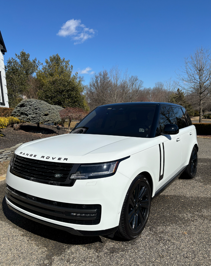 Luxury sedan with crystal-clear reflection after paint correction and ceramic protection.