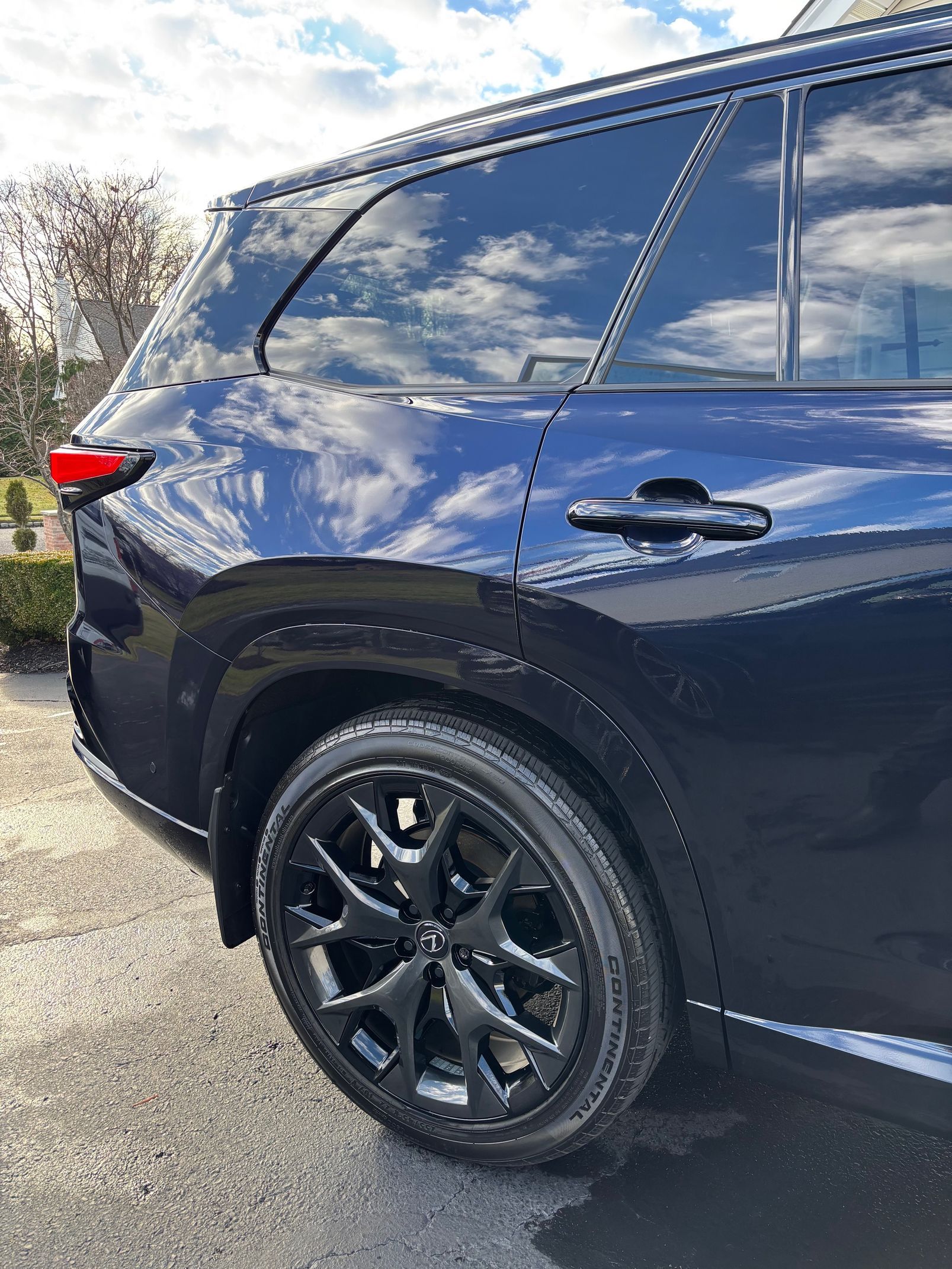 Blue SUV exterior reflecting sky after ceramic coating by CC Cleaning & Detailing.