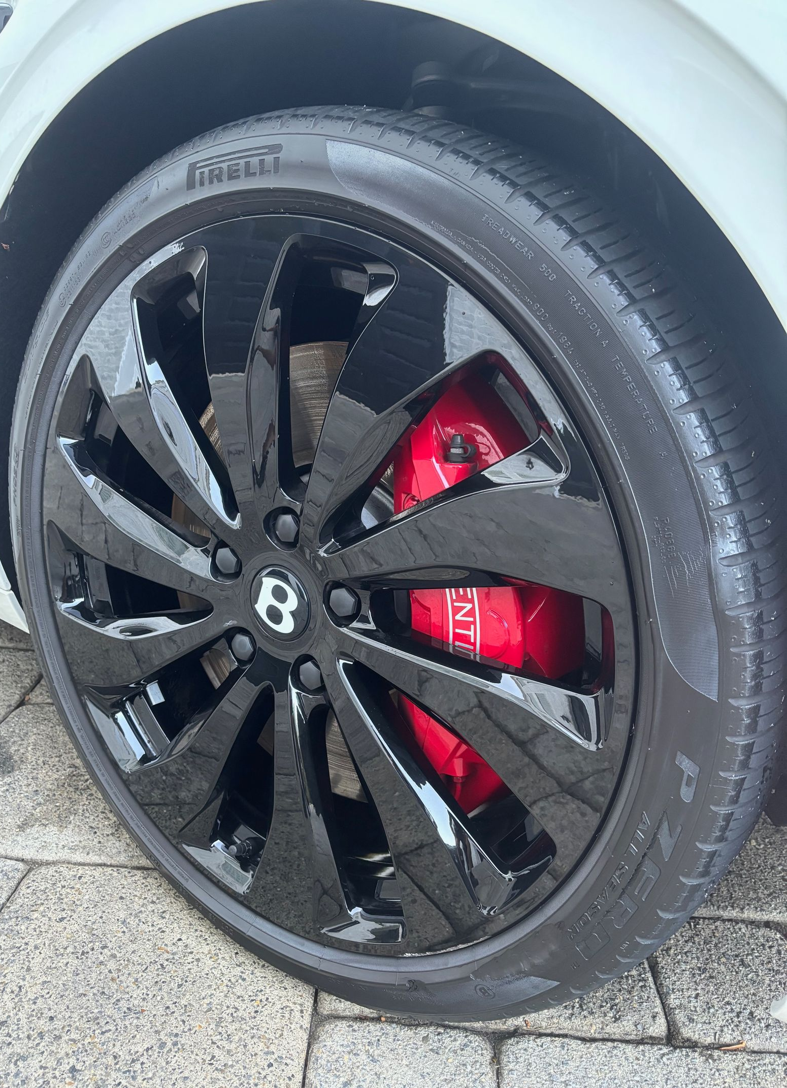 Polished black alloy wheels and clean tires after premium detailing in New Jersey.