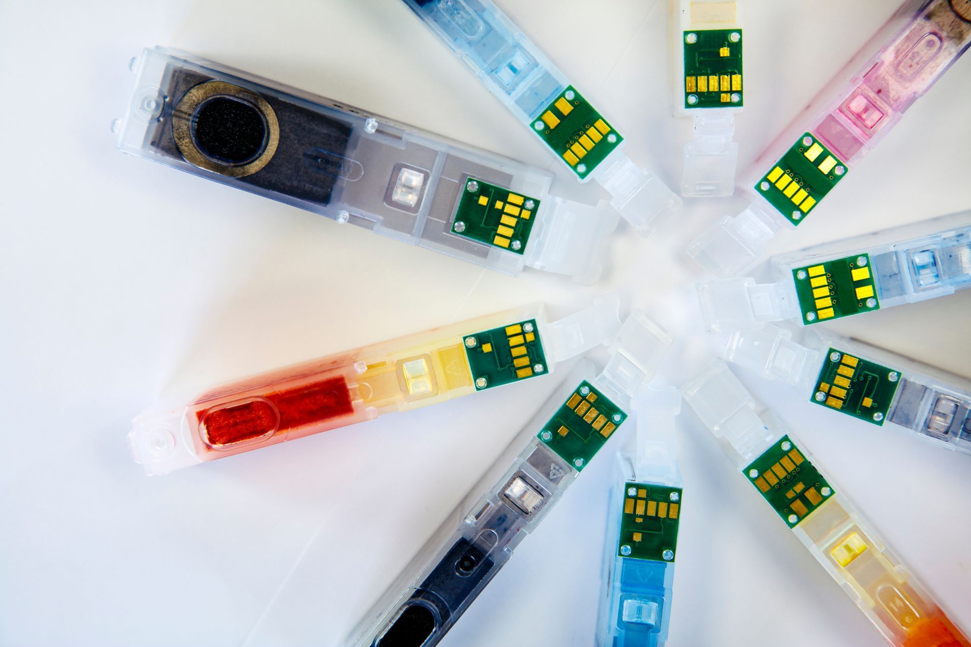 Set of colorful ink cartridges arranged in a circle, showcasing a vibrant spectrum of colors.