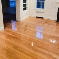 Glossy hardwood floor reflecting ambient light in a room.