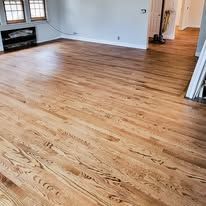Hardwood floors in a sunlit room.