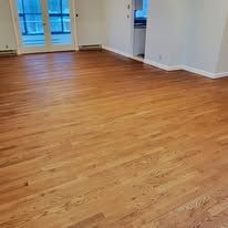 Hardwood floor in a room, brown tone, well-lit.