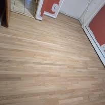 Light wood flooring, visible near a wall.