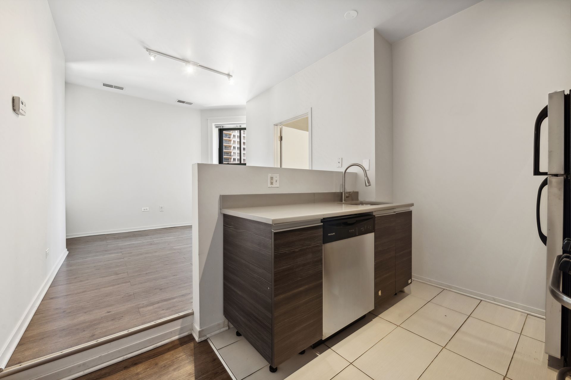 A kitchen with stainless steel appliances and wooden cabinets