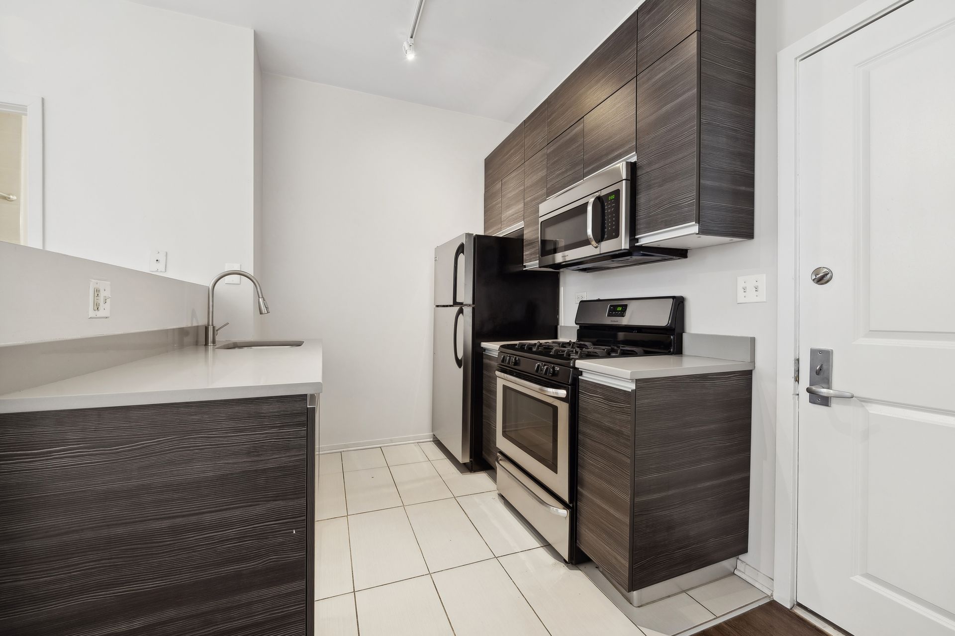 A kitchen with stainless steel appliances and wooden cabinets