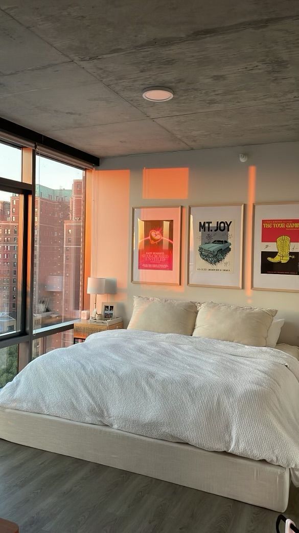 A bedroom with a large bed and a lot of windows.