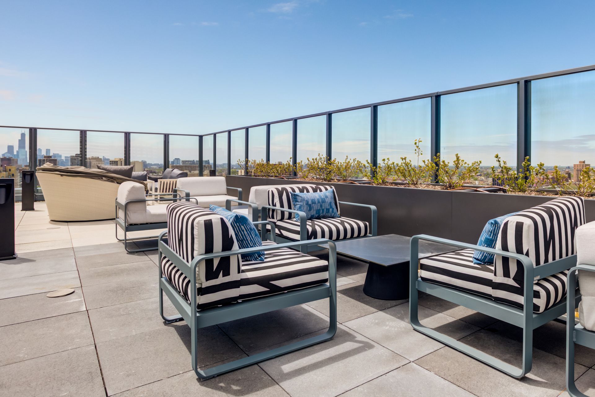 There are a lot of chairs and a table on the patio.
