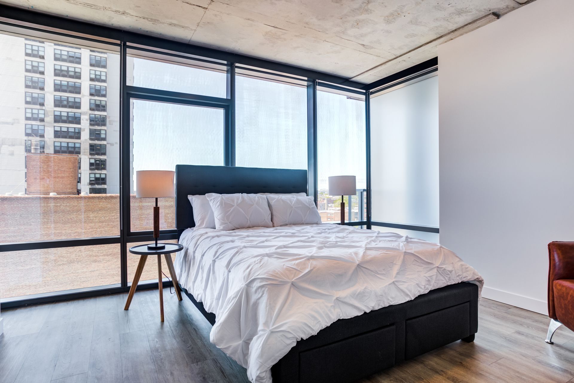 A bedroom with a large bed and lots of windows