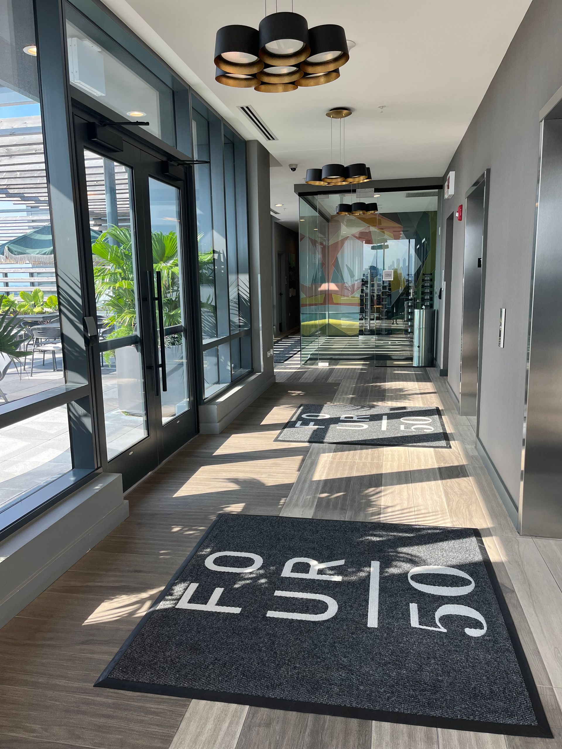 A long hallway with a rug on the floor that says ' s ' on it.
