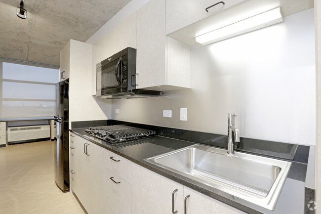A kitchen with stainless steel appliances and a sink