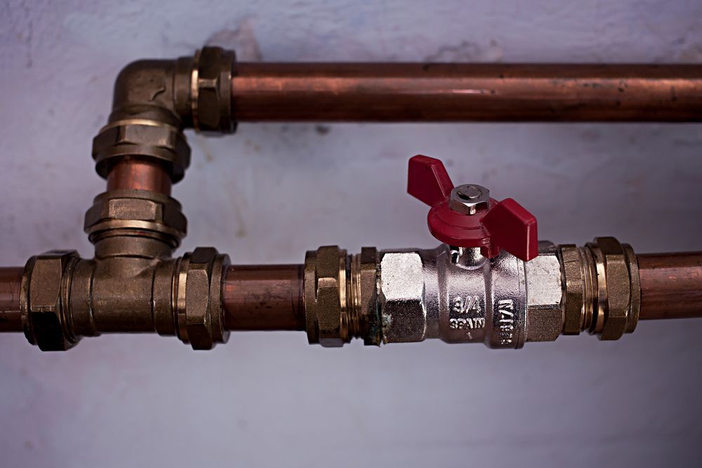 Copper Pipes Connected With Brass Fittings, Including a Red-handled Valve — Full On Plumbing & Gas in Palmerston, NT