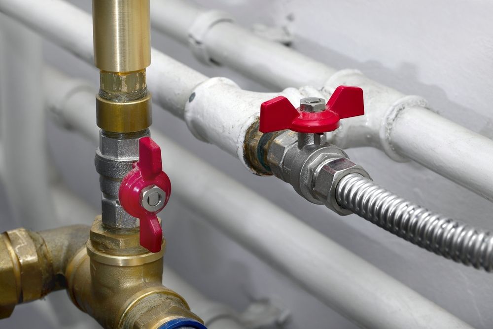 Close-up of Plumbing Pipes With Two Red-handled Valves — Full On Plumbing & Gas in Nightcliff, NT
