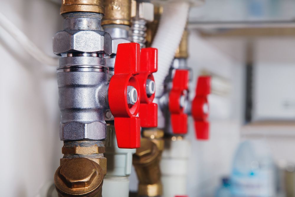 Close-up of Plumbing Pipes With Several Red-handled Valves — Full On Plumbing & Gas in Winnellie, NT