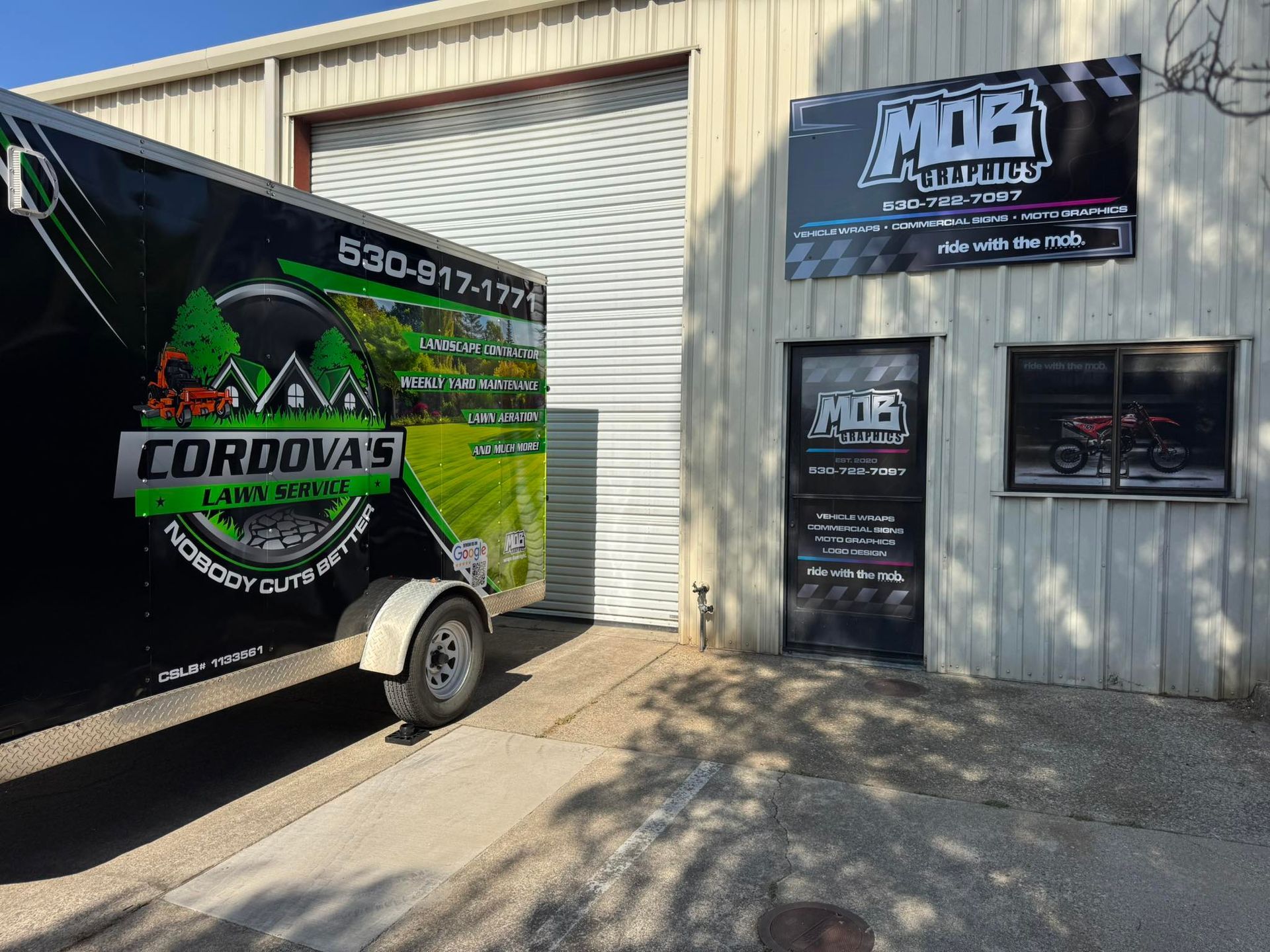 A trailer and building. The trailer says 