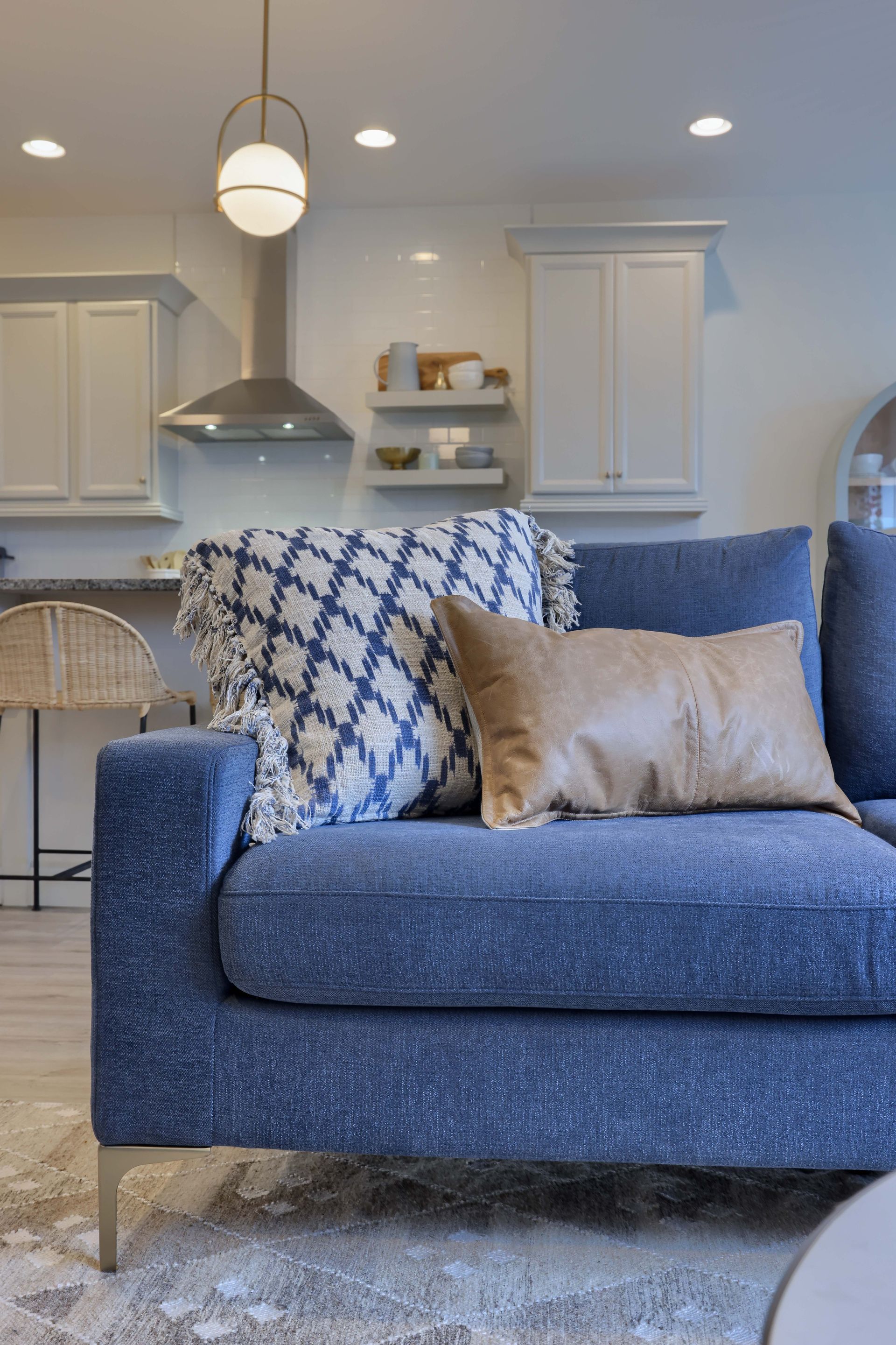 Coastal blue couch with textured pillows | Design by Haven Made Interiors