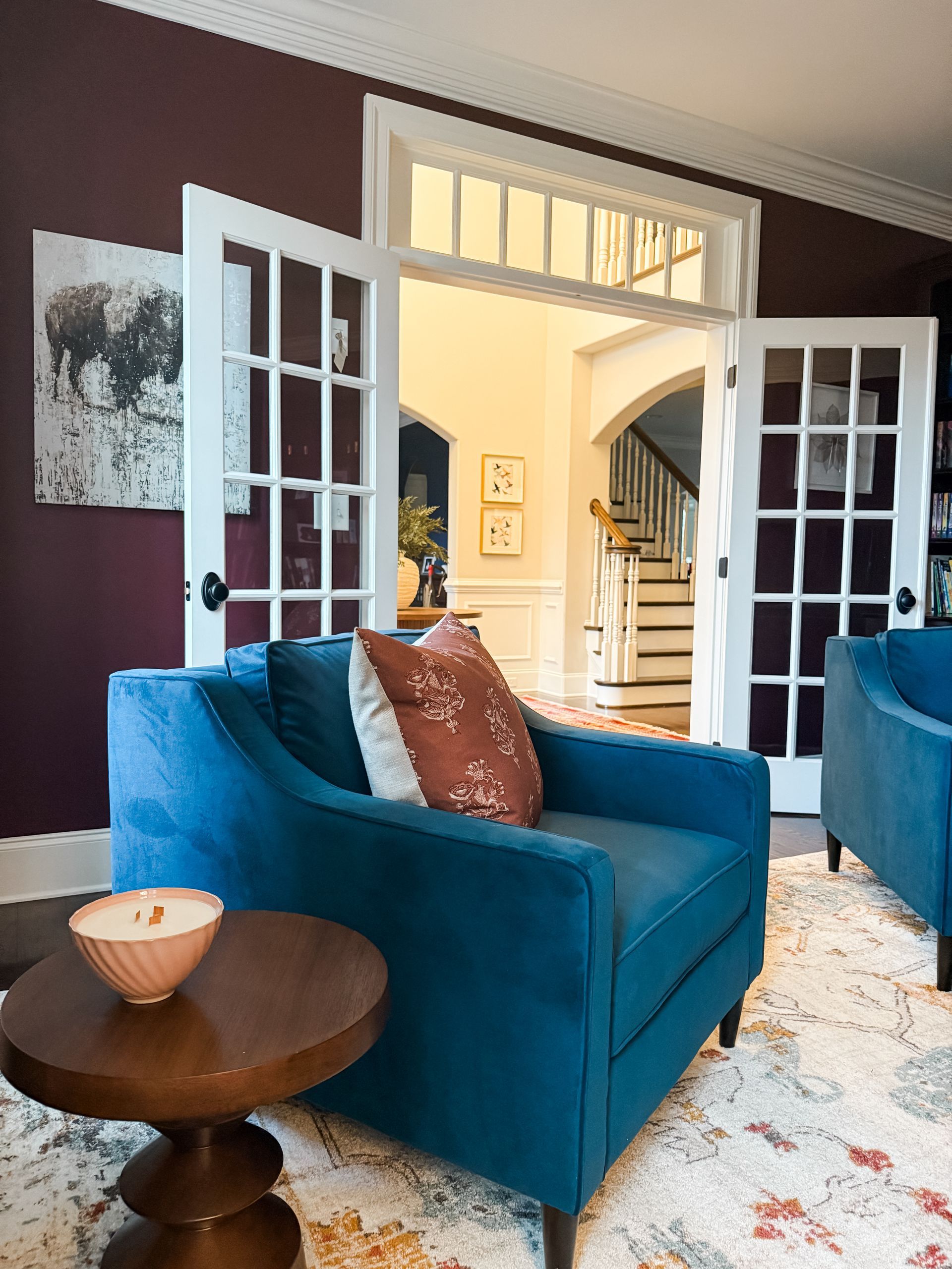Home office with french doors and two blue velvet armchairs.