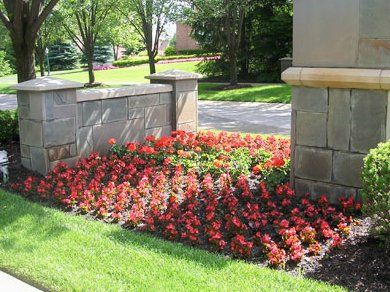 Commercial Landscaping with Stones — Stone Decoration and Red Flowers in Troy, MI