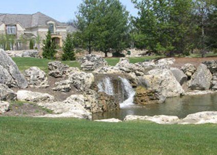 Expert Pond Management — Residential Pond Landscape with Stones in Troy, MI