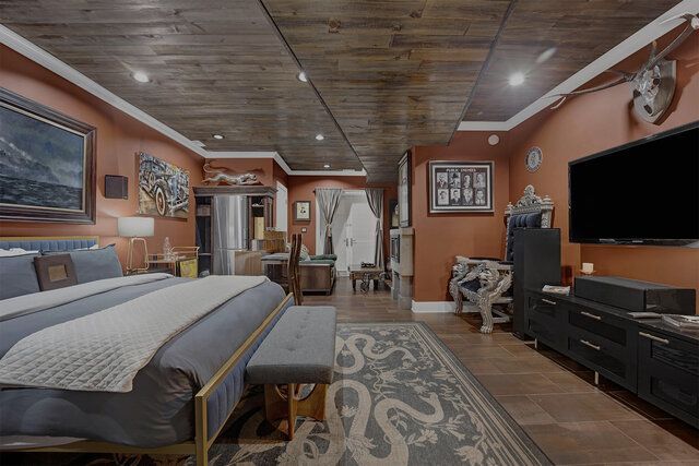 Bedroom with rustic wood ceiling, orange walls, large TV, bed, and ornate rug.