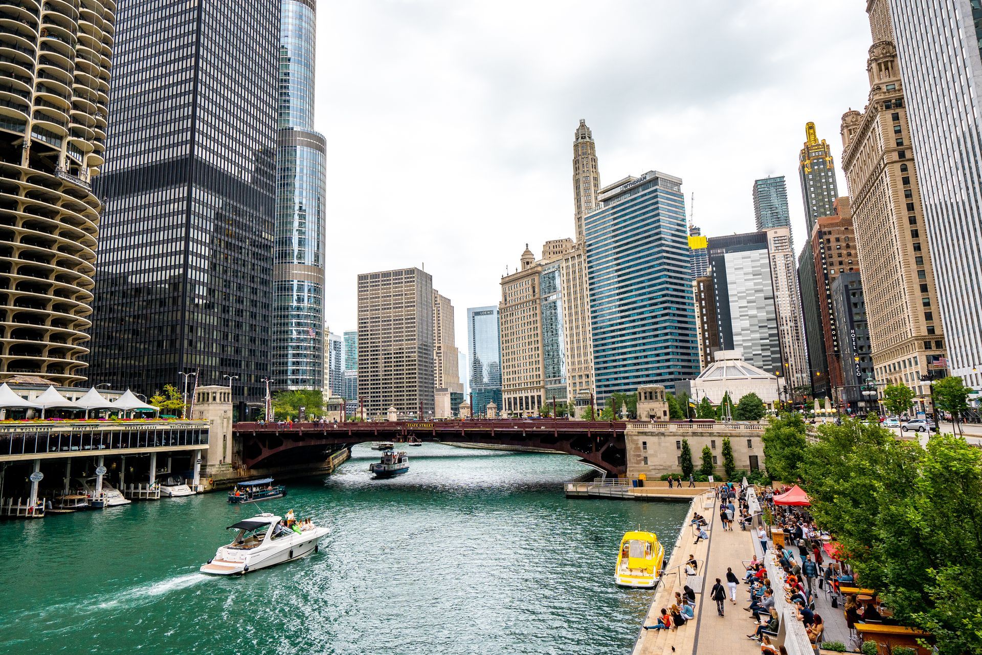 A boat is going down a river in a city.