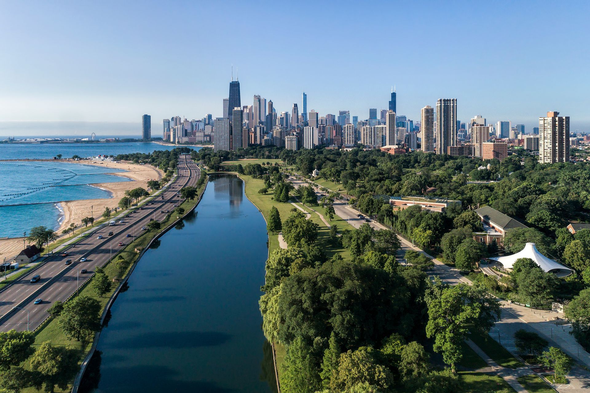 An aerial view of a river with a city skyline in the background.