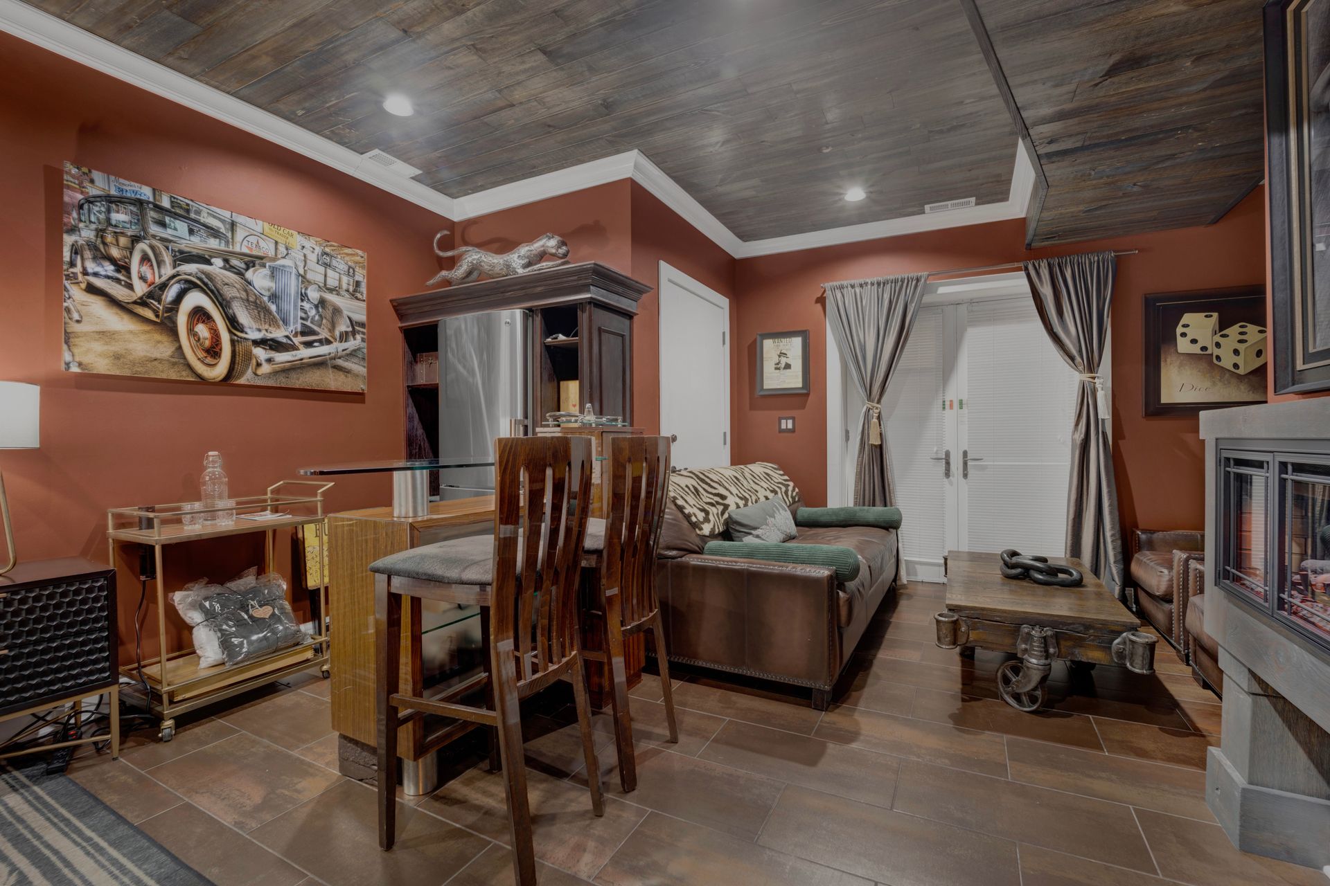 A living room with a couch , table , chairs and a fireplace.