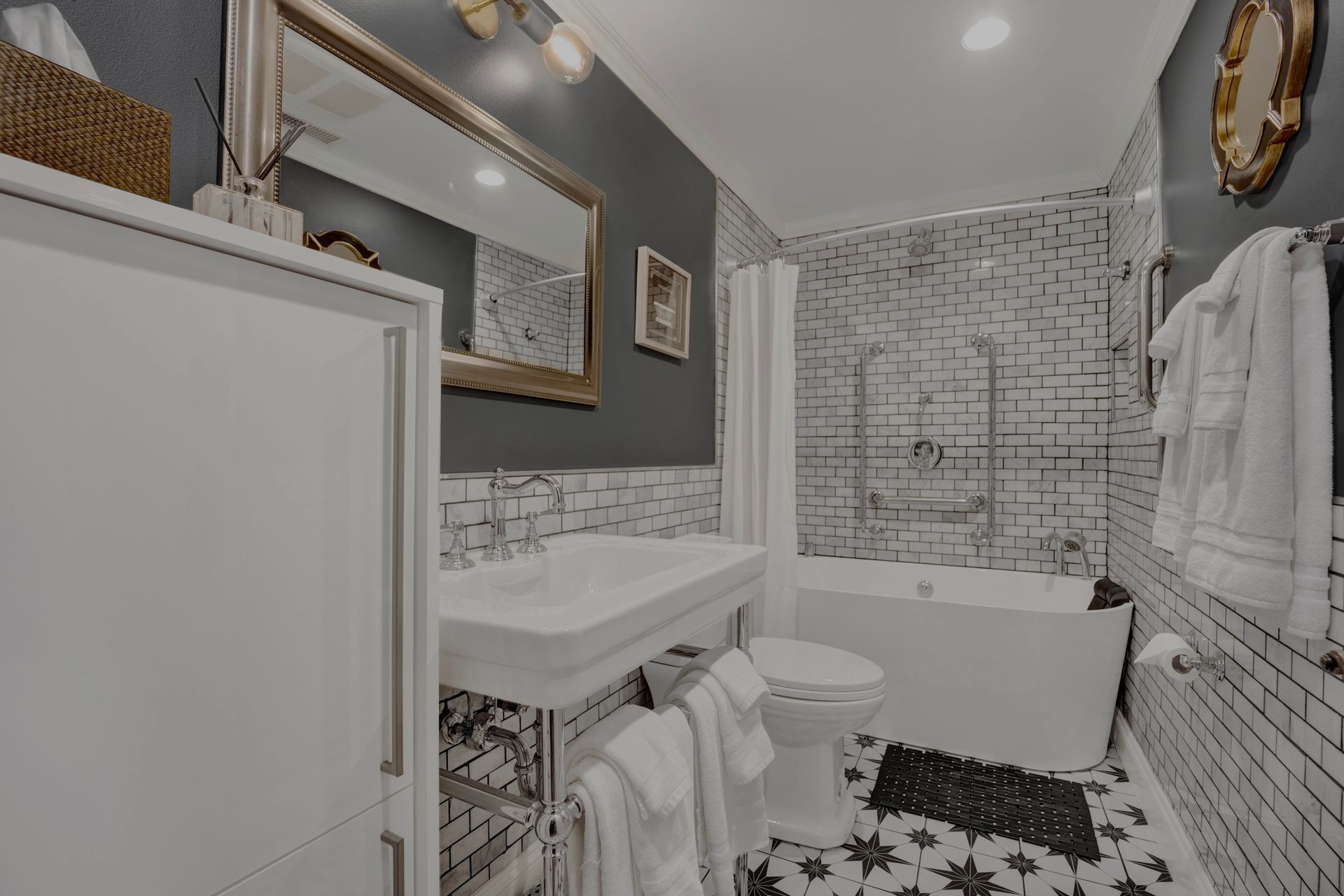 A bathroom with a sink , toilet , bathtub and mirror.