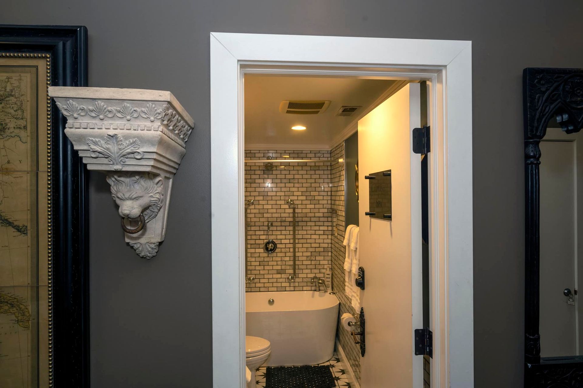 A bathroom with a bathtub , toilet , and mirror.
