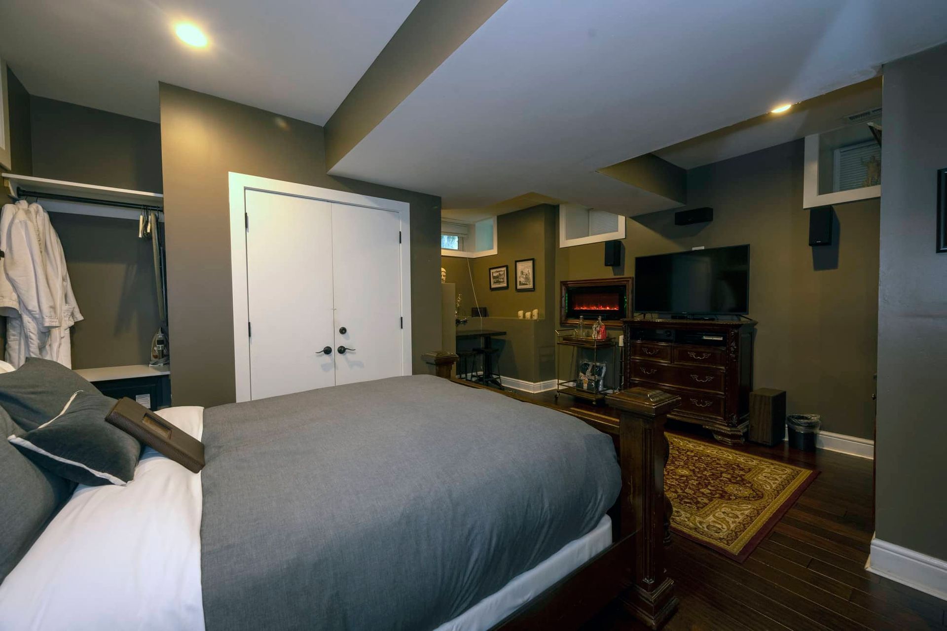 A bedroom with a large bed and a television