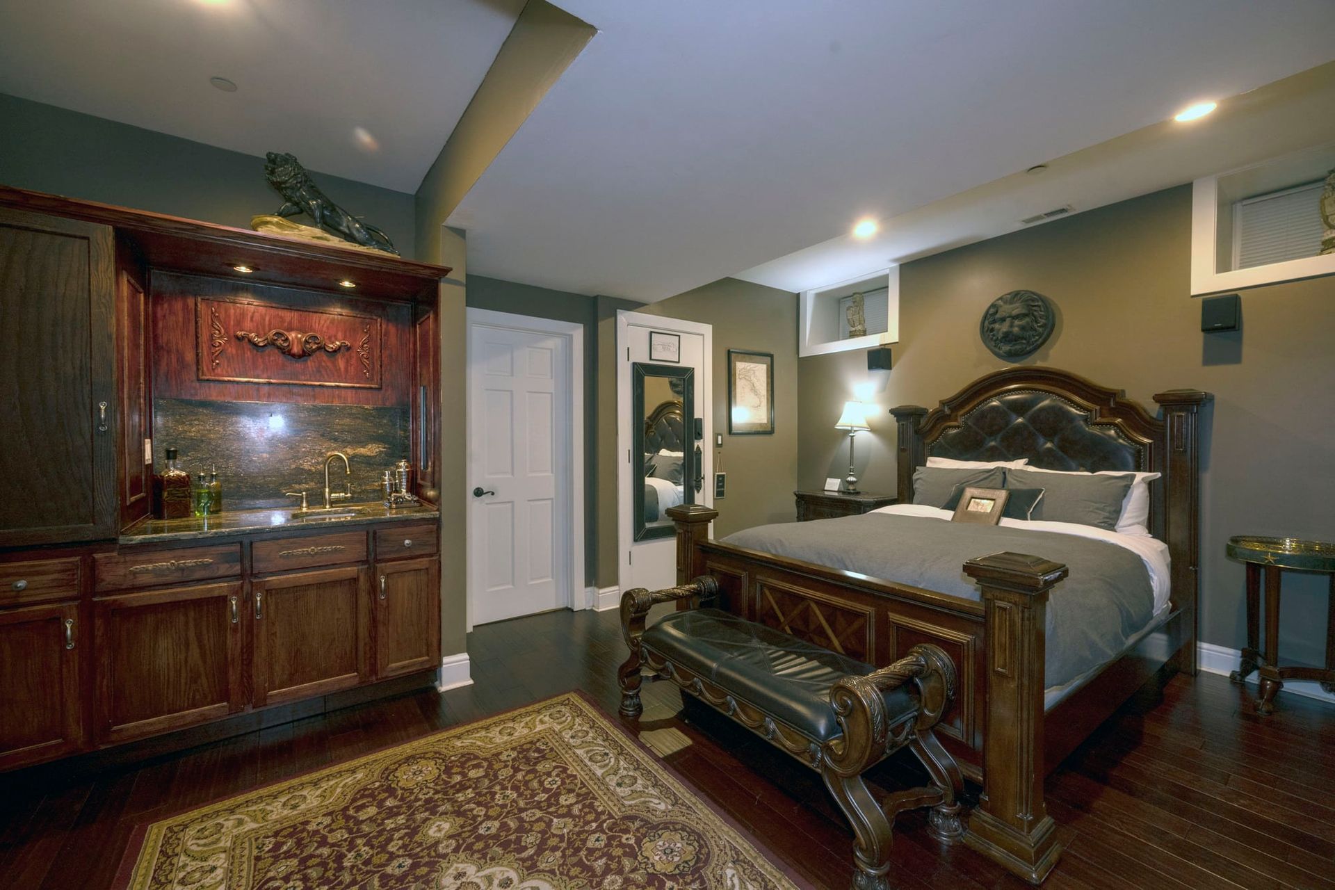 A bedroom with a large bed and a bench