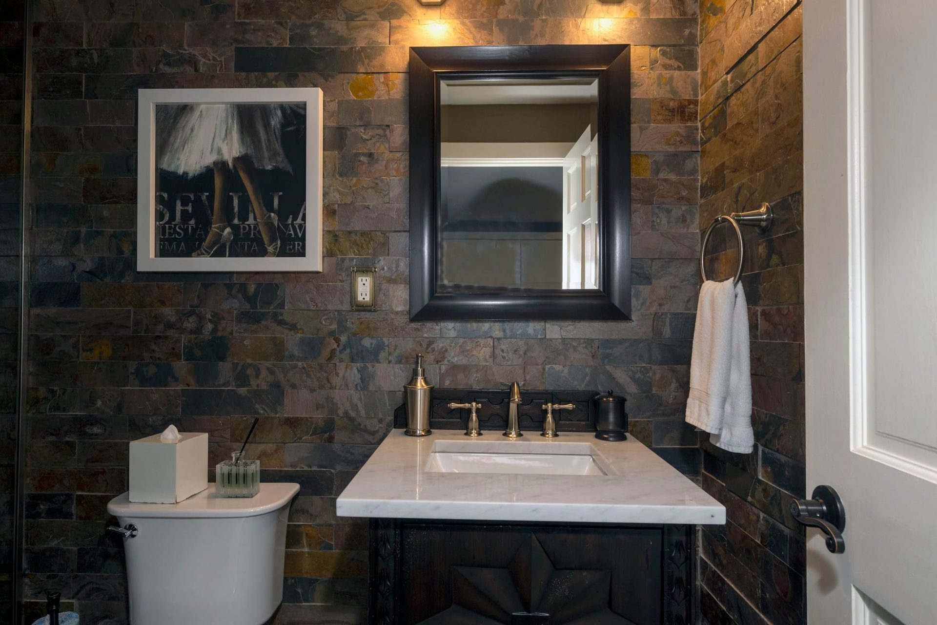 A bathroom with a sink , toilet and mirror.