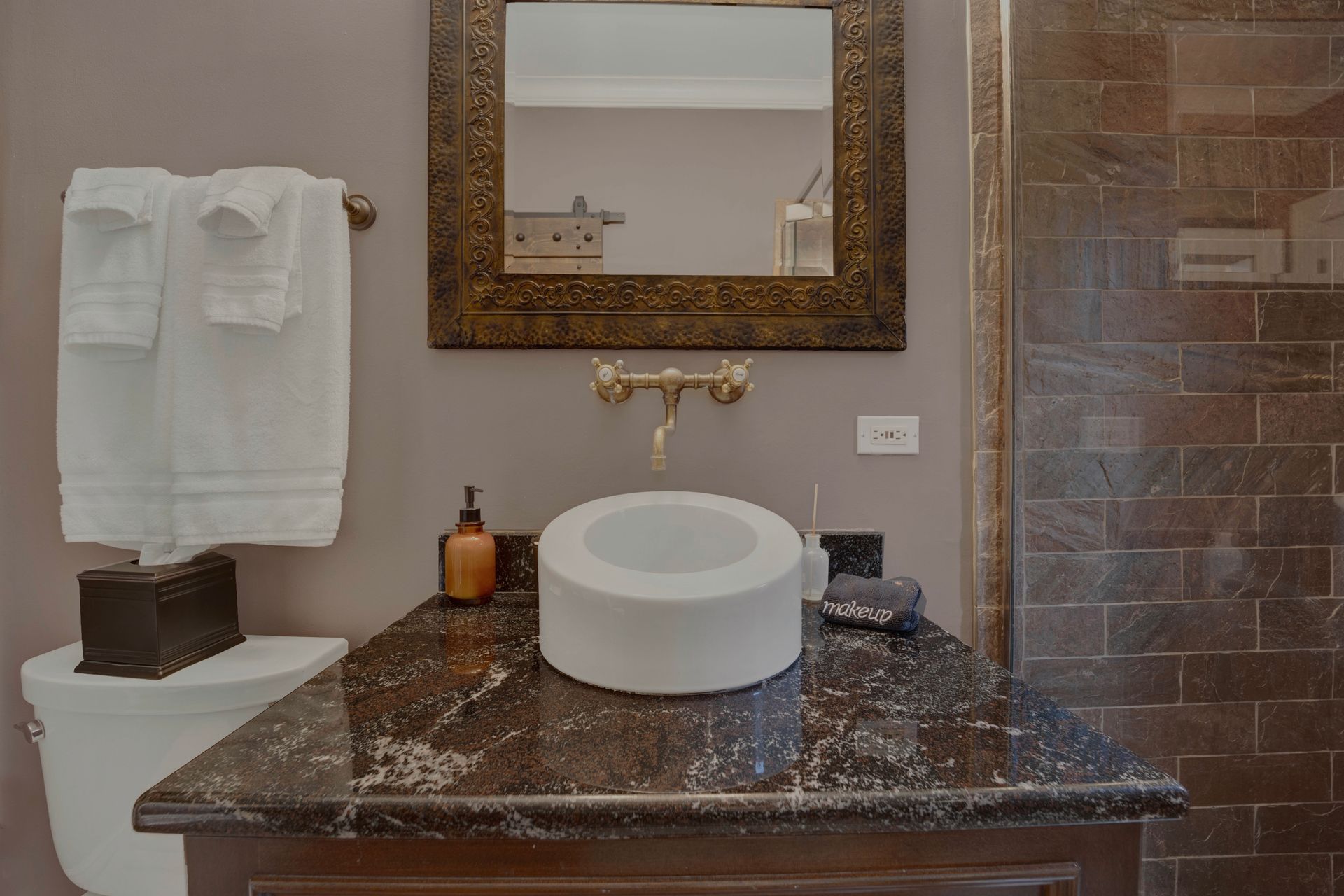 A bathroom with a sink , toilet and mirror