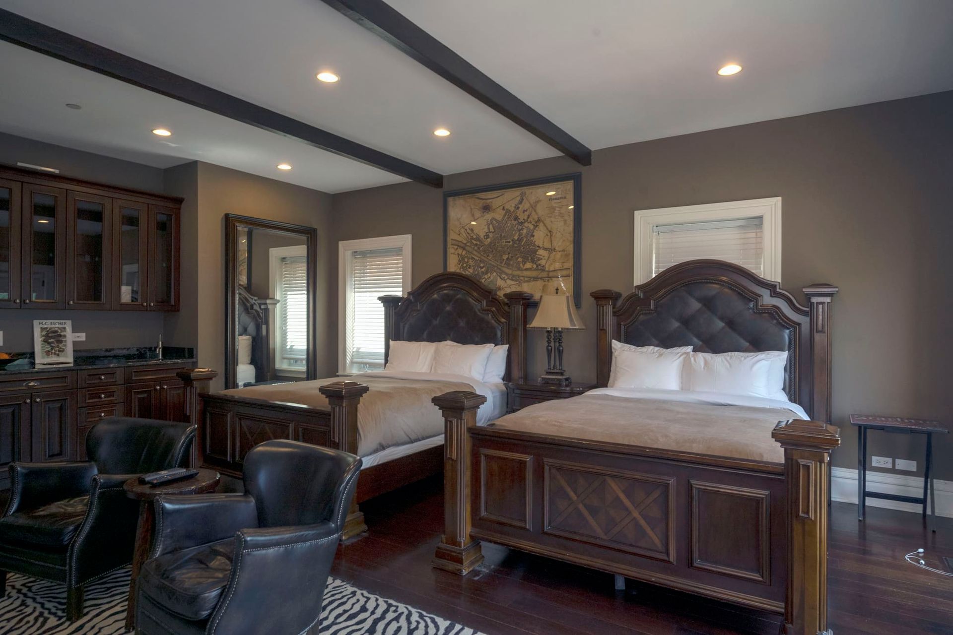 A bedroom with two beds and a living room